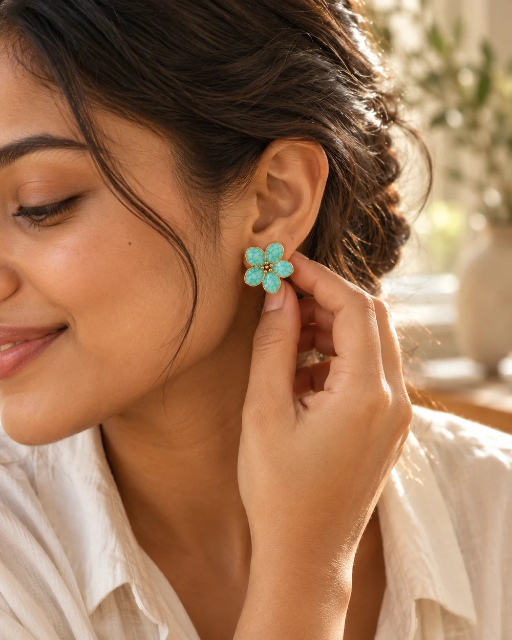 A quiet getting-ready moment, adjusting a turquoise flower earring